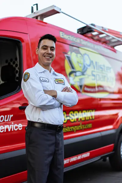 Closeup of Emilio, a Mister Sparky Electrician Tech, in front of his service van at a home in Gainesville, FL